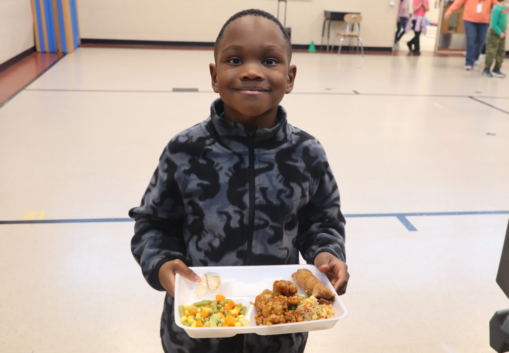 student with lunch tray