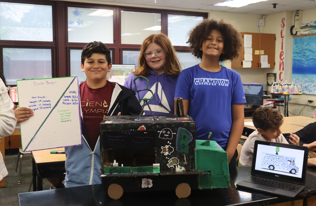 group of three kids with food truck project