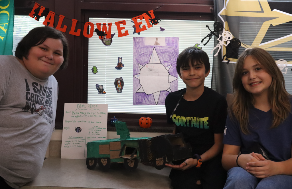 group of three kids with food truck project