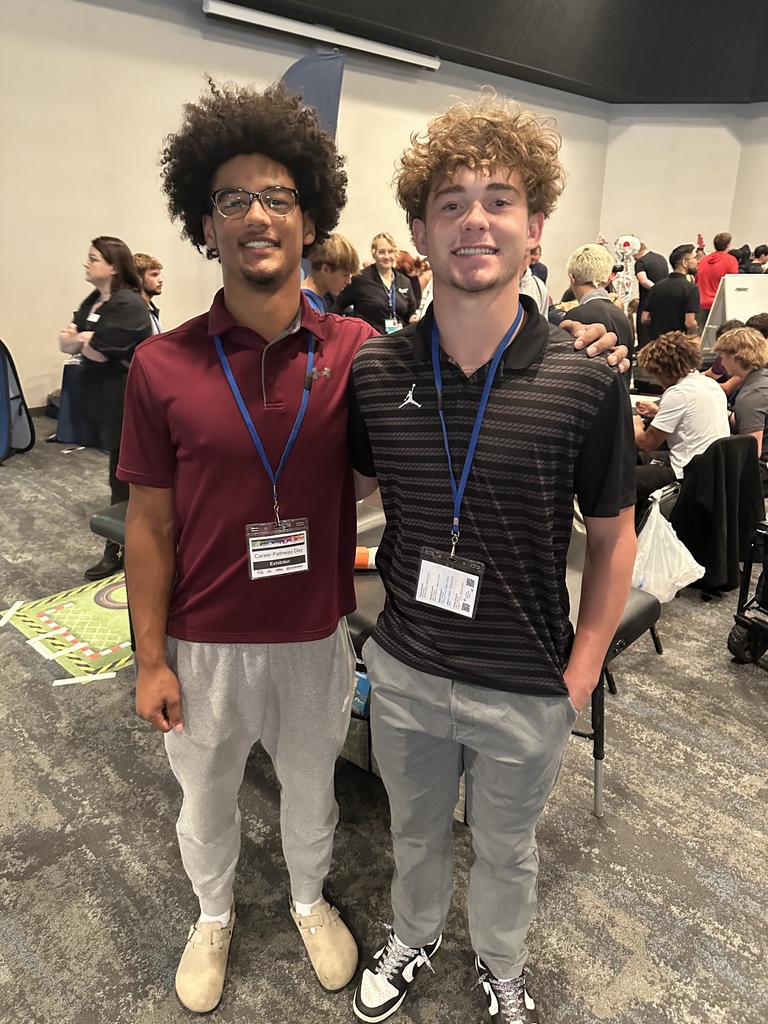 two boys standing together smiling