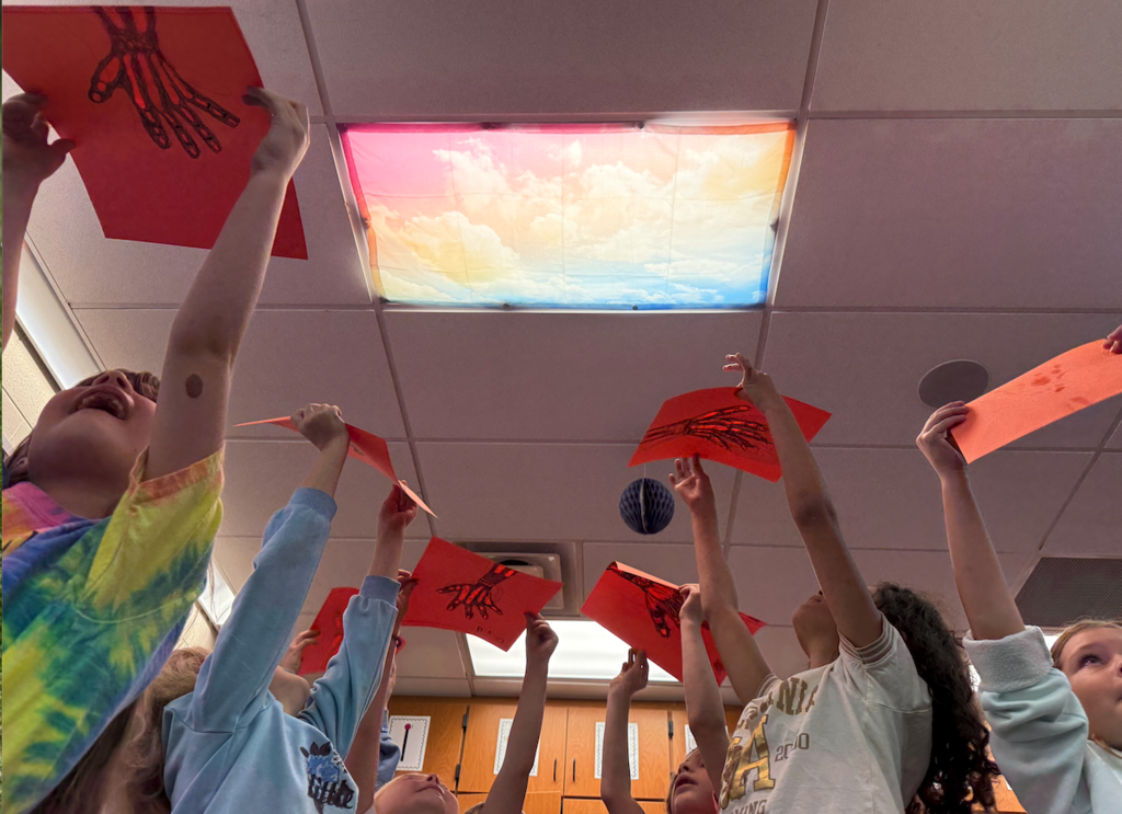 kids holding up paper