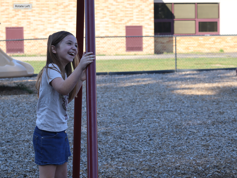 little girl smiling on playground