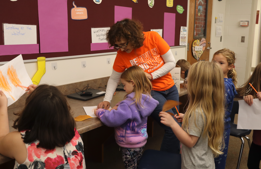 teacher helping students