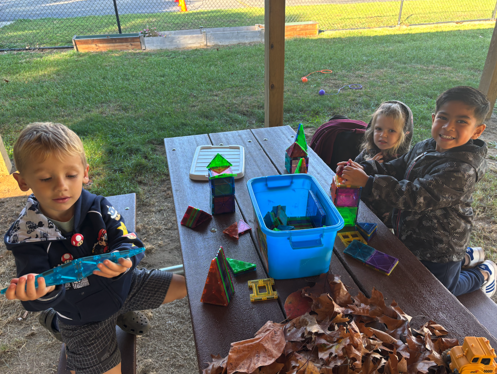 kids sitting at picnic tables