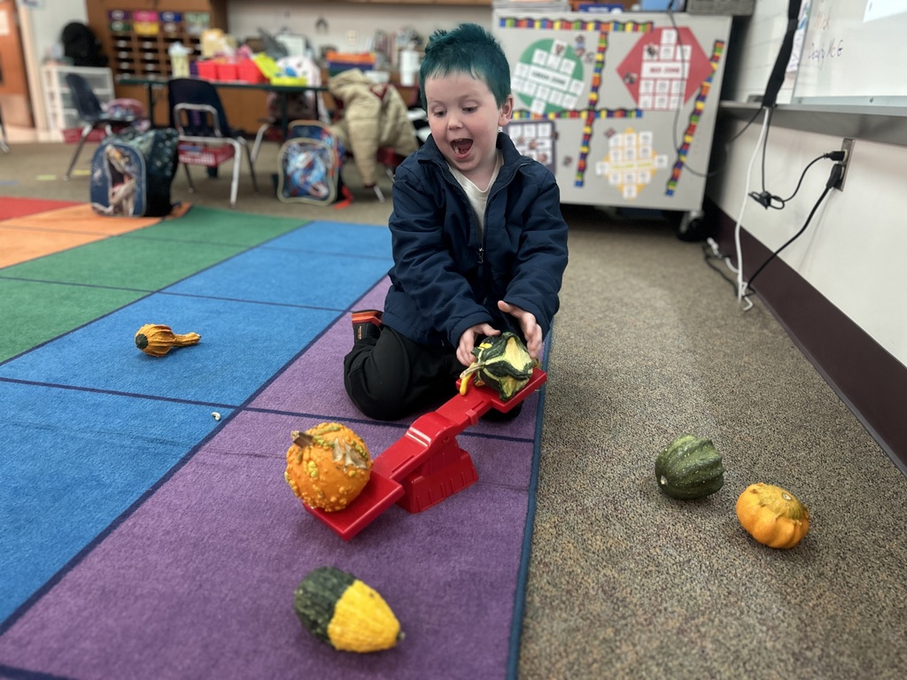 little boy playing with gourds