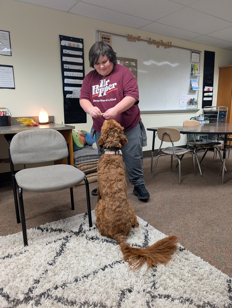 young man giving dog a treat