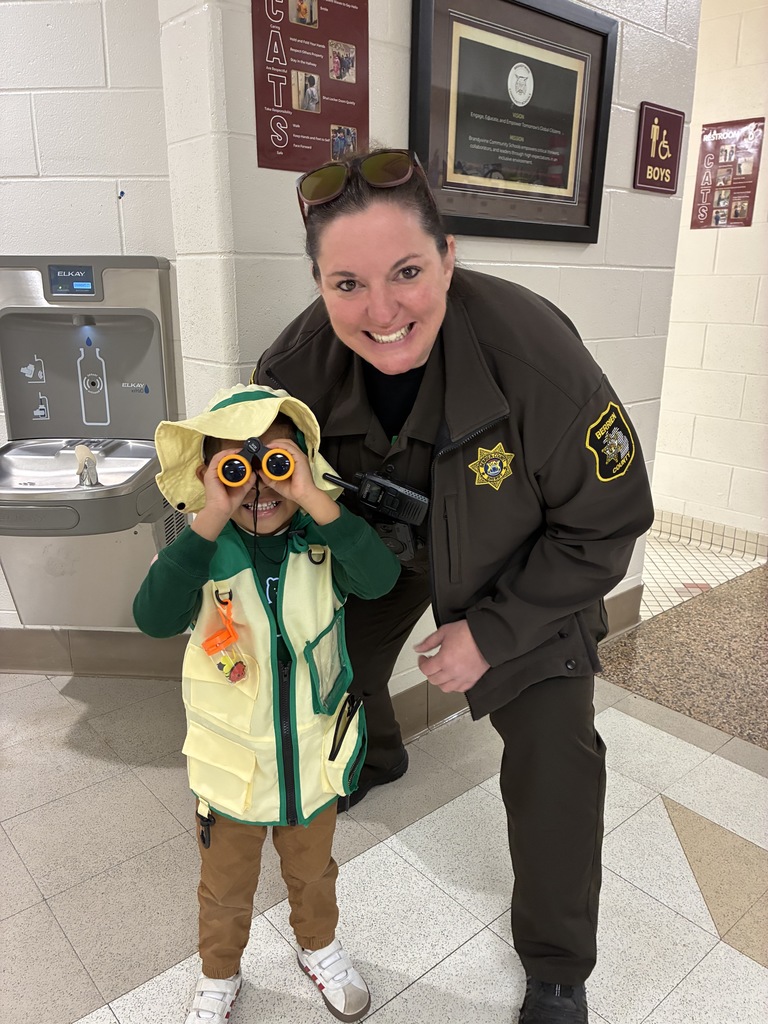 SRO with little boy holding binoculars