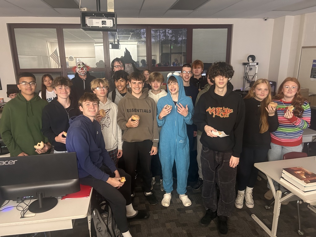 students holding donuts