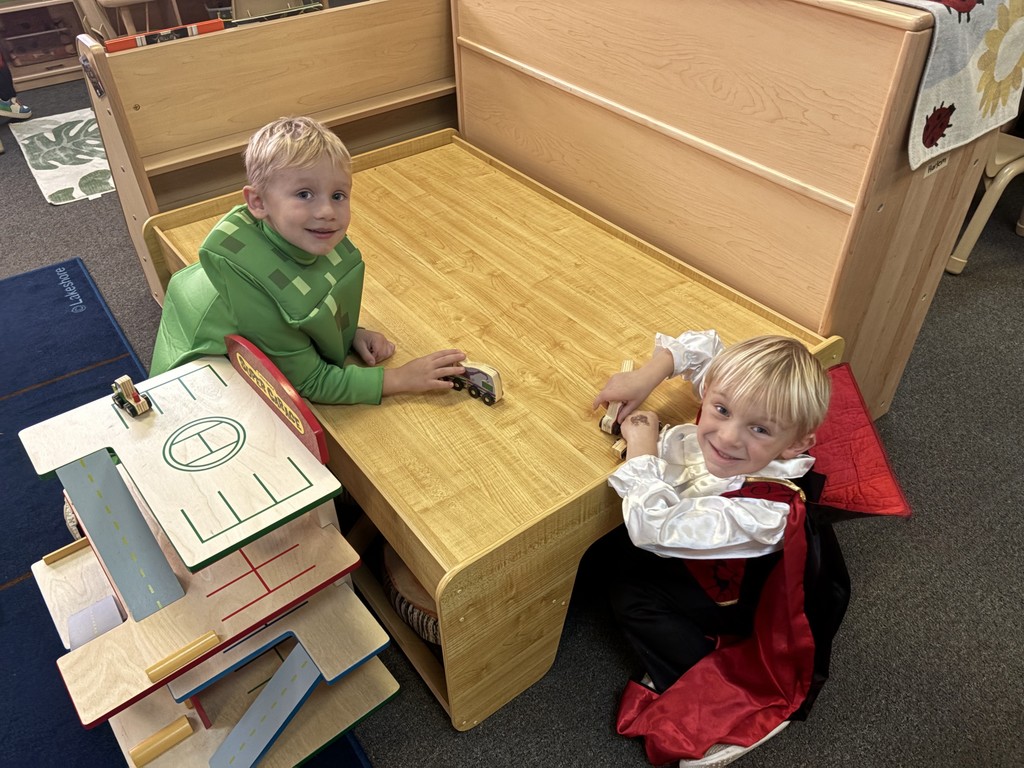 little boys playing at table in costumes
