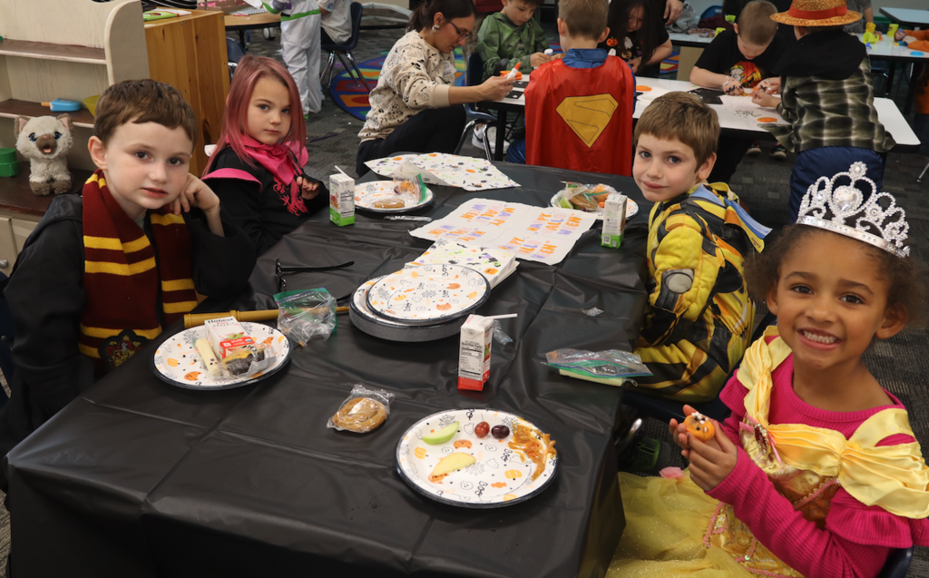 students eating treats in costumes