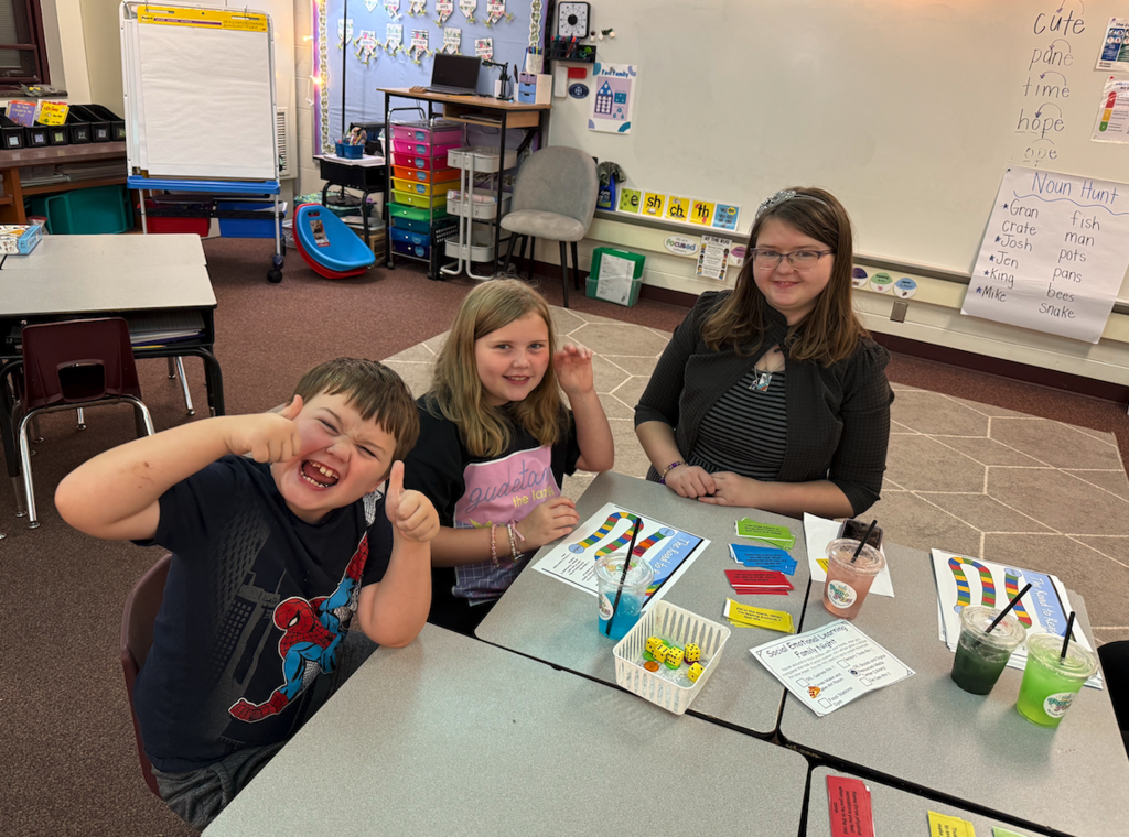 three kids sitting tables
