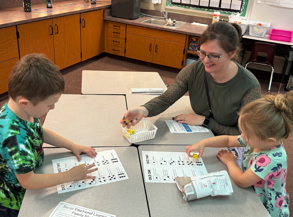 two kids sitting at table with parents