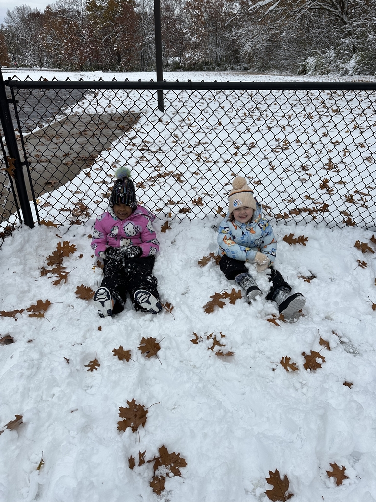 two girls sitting in the snow