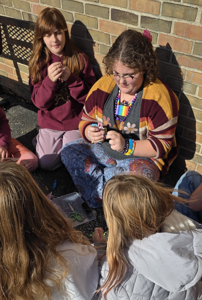 girls making friendship bracelets