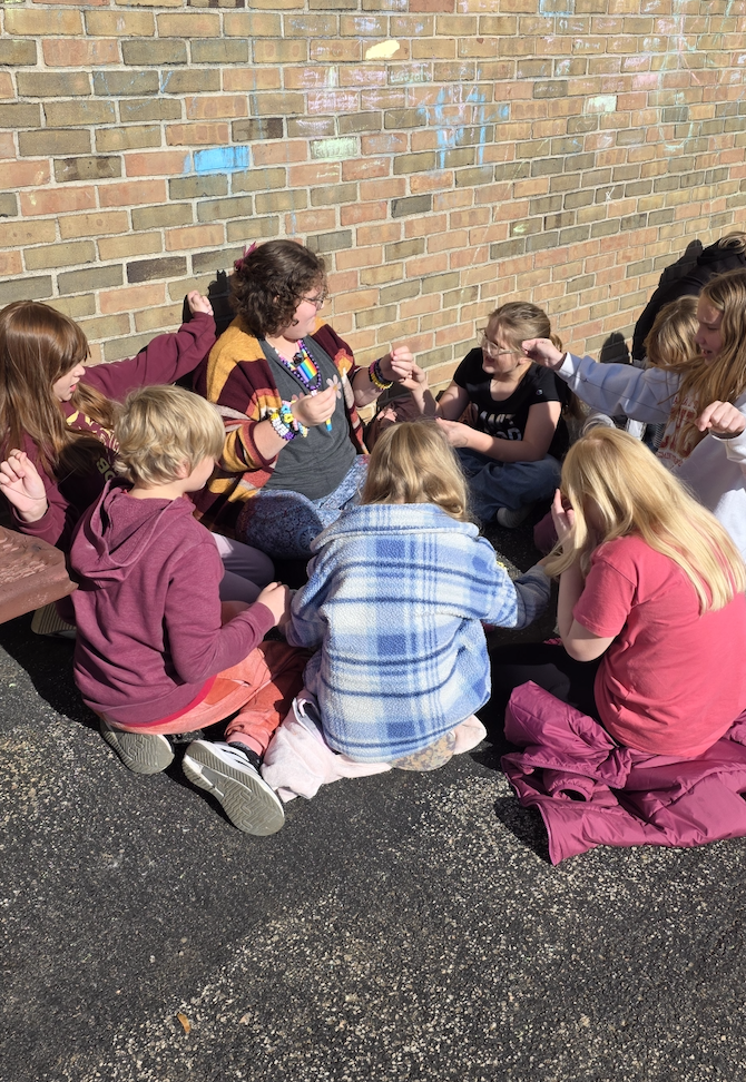 girls making friendship bracelets