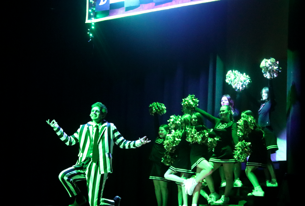 beetljuice on stage with cheerleaders