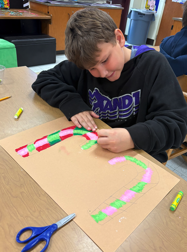 boy drawing candy canes