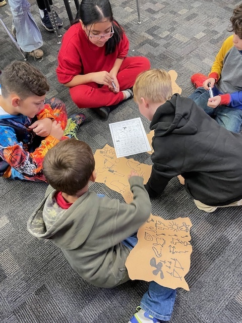 students gathered around in a circle on the floor