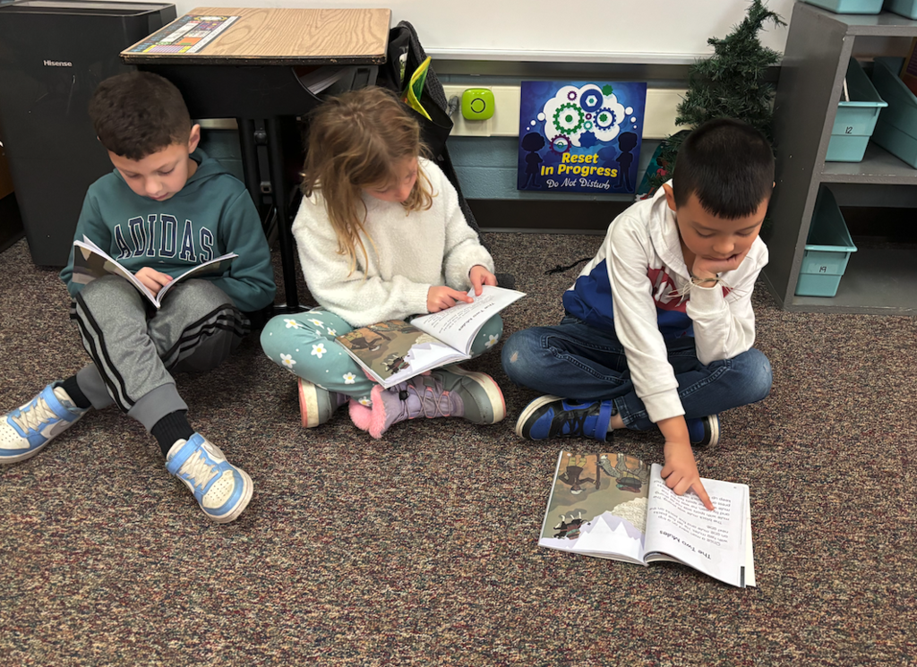 two boys and one girl reading