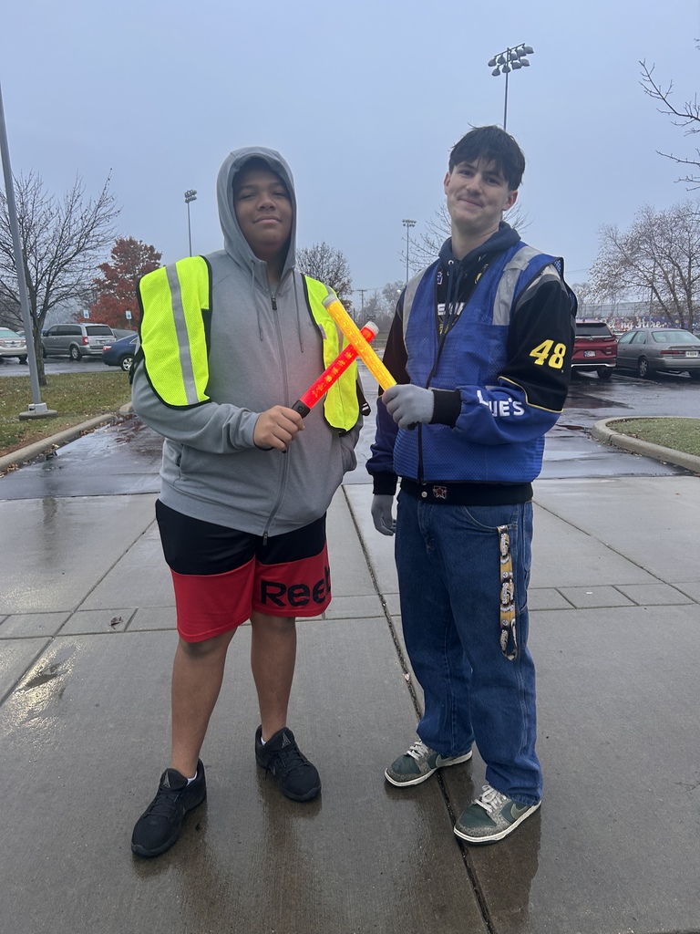 two boys directing traffic