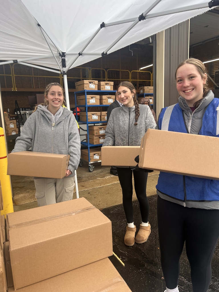 three girls loading boxes
