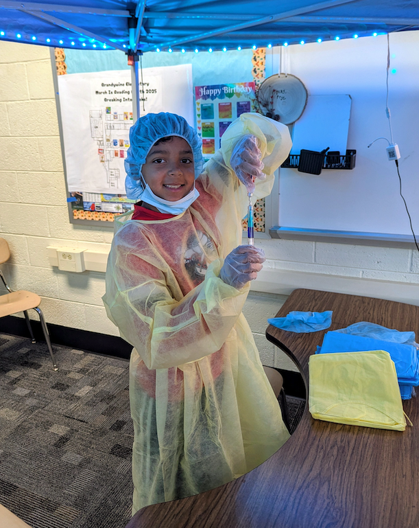 student using a fake syringe
