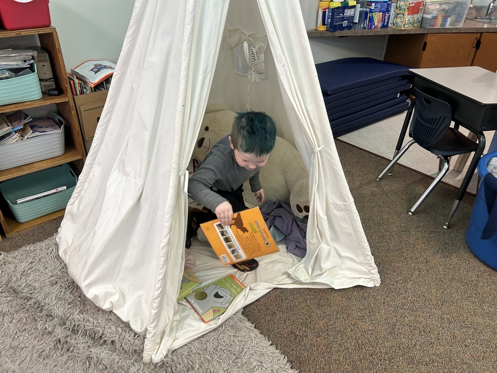 kid sitting in a tent
