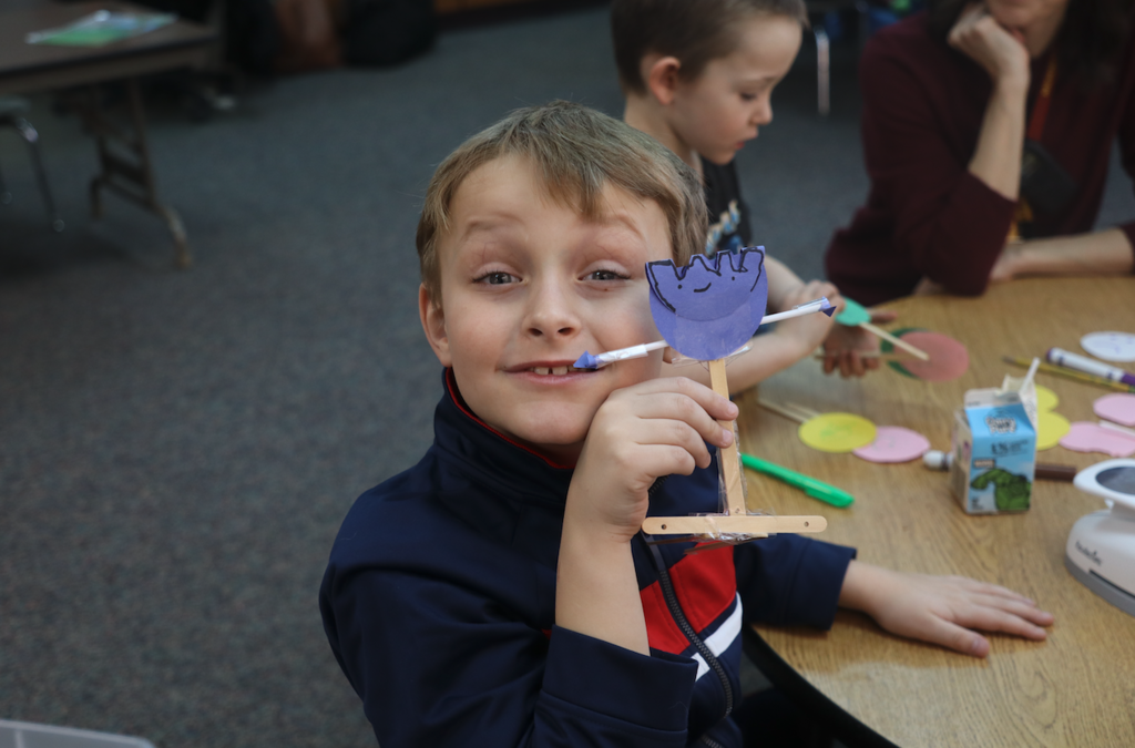 Easton holding up his roadblox character