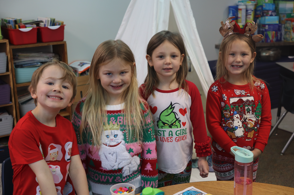 4 kids dressed up in Christmas