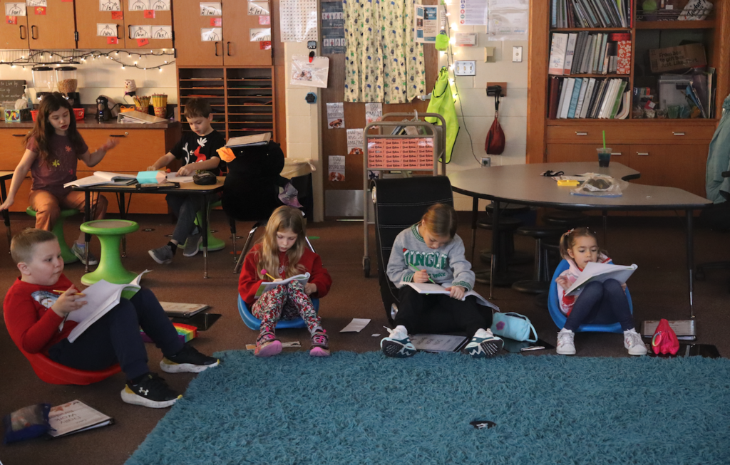 little kids writing in workbooks