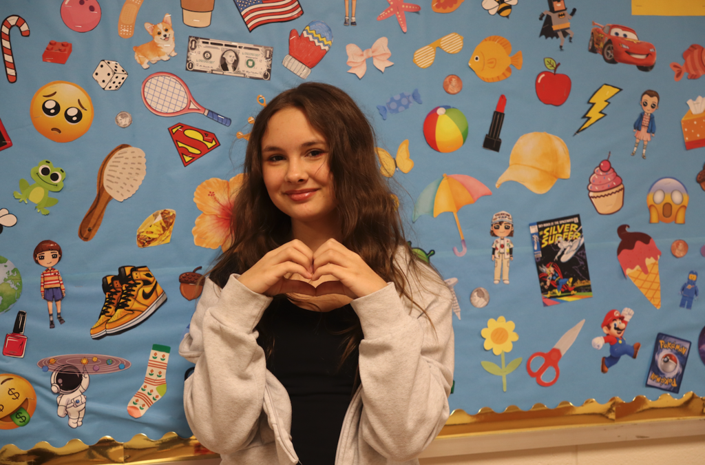 girl giving heart shape