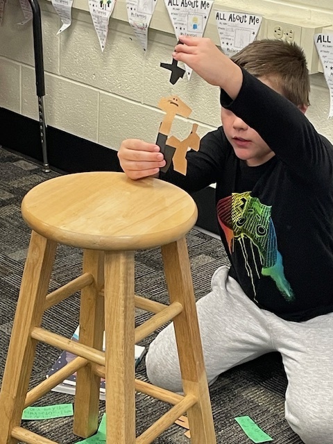 student doing a puppet show