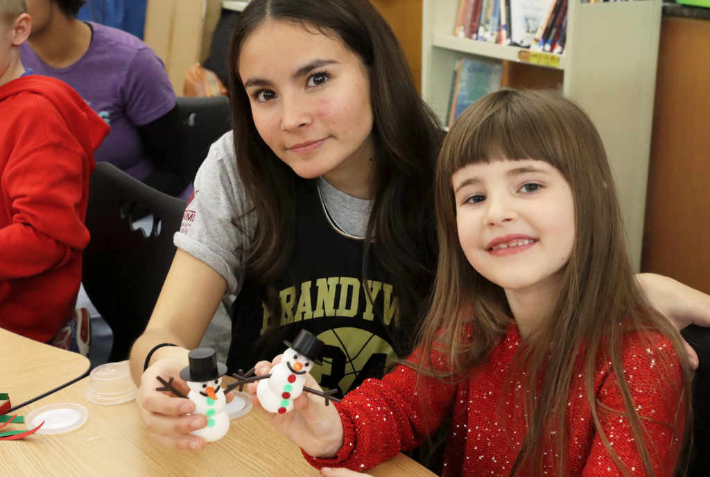 teenage girl with little buddy girl from Merritt