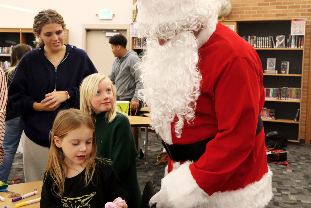 two girls meeting Santa clause