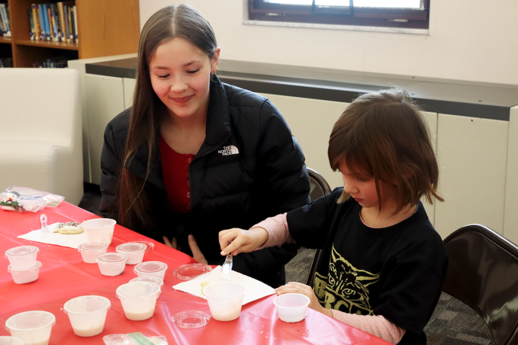 teenage girl with little buddy girl from Merritt