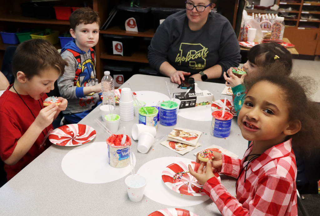 little kids eating Christmas cookies