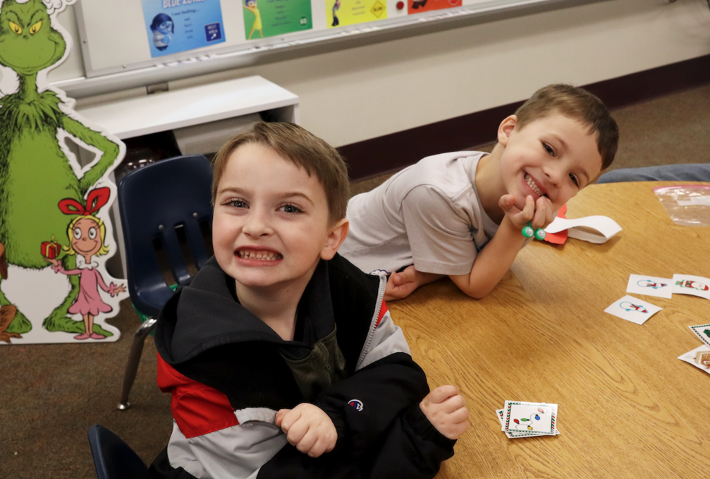 two little boys and table smiling