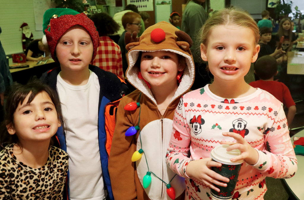 4 little kids smiling at camera