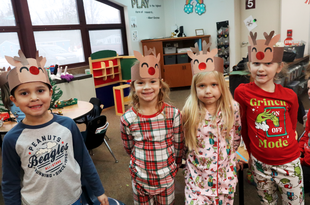 four little kids in reindeer hats