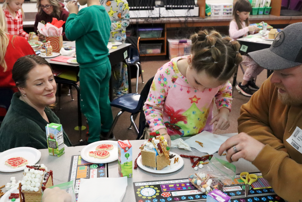 little girl making a gingerbread house