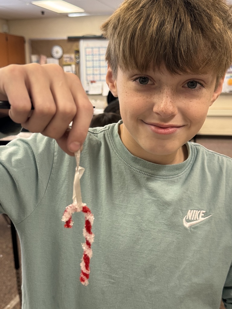 boy holding candy cane