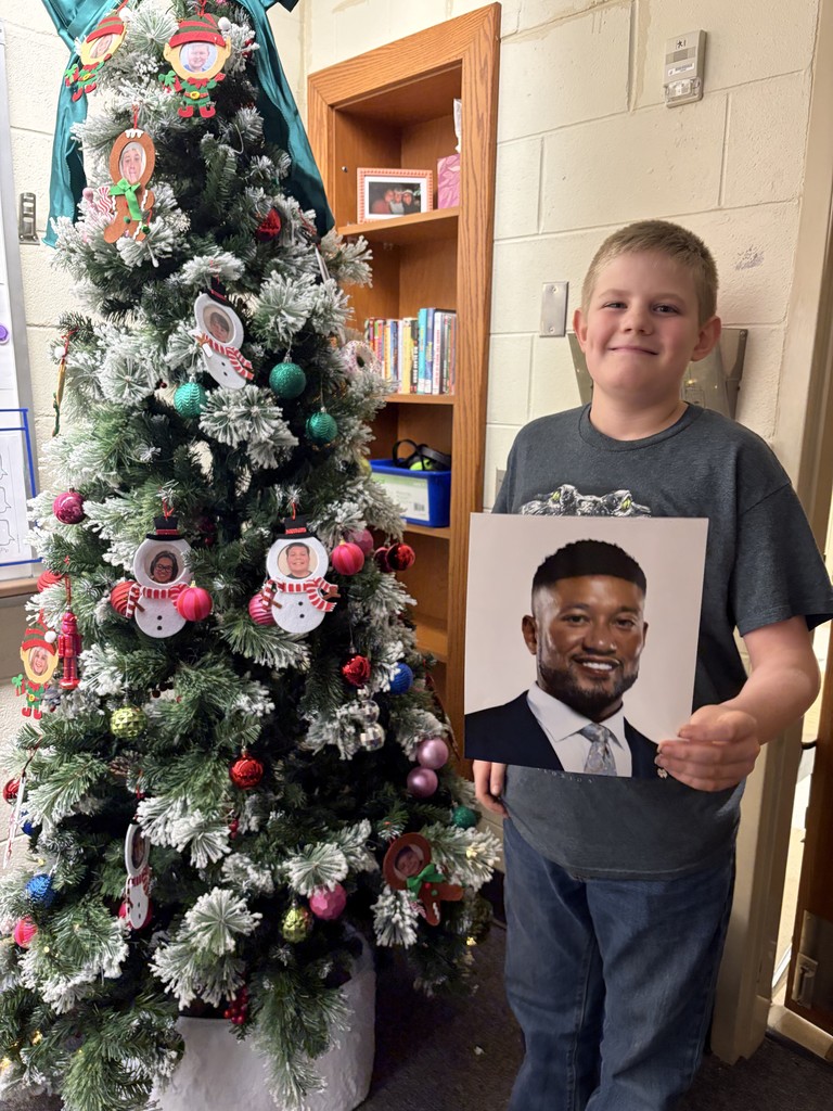 student holding up Marcus freeman picture