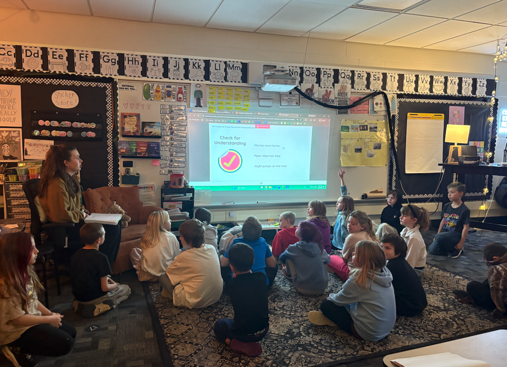 students sitting in class looking at the screen learning personal narratives