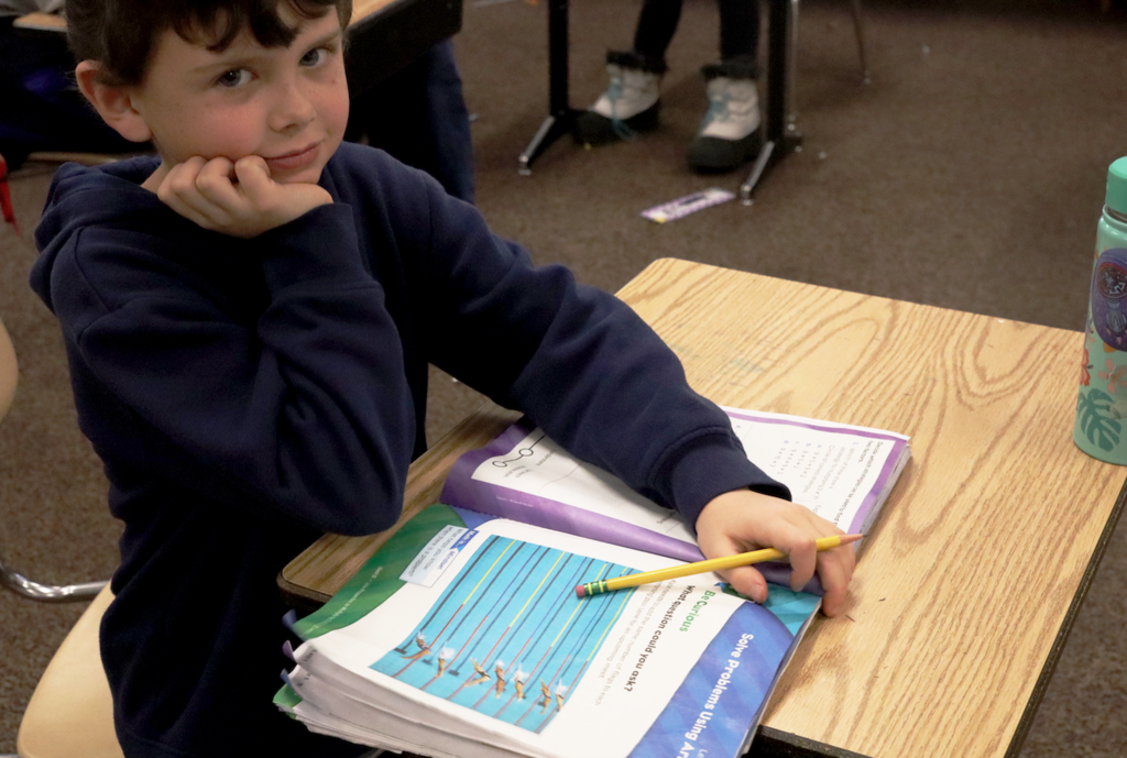 little boy doing math work