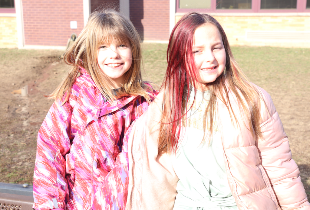 two little girls outside in their coats