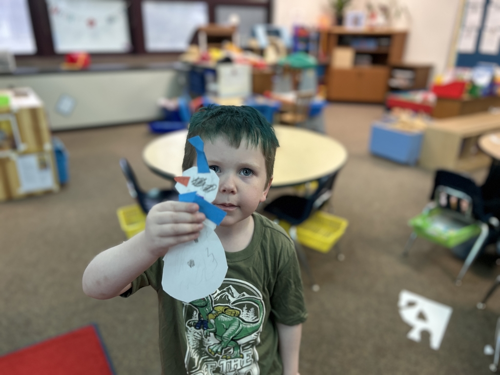 student holding paper snowman