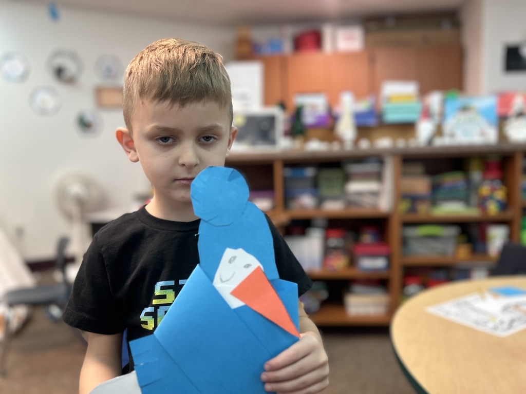 student holding paper snowman