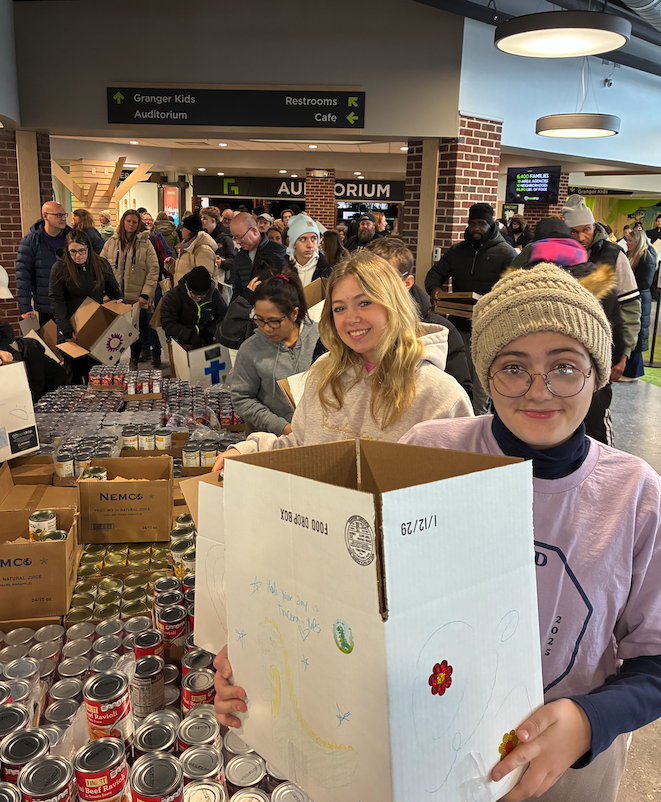 students filling boxes with food at food drop