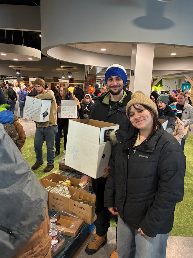 students filling boxes with food at food drop