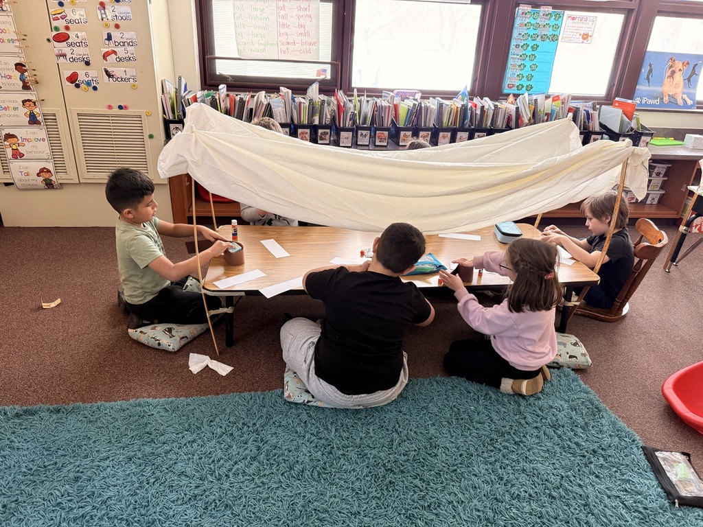 student under covered wagon